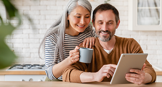 older couple working on a tablet in their kitchen_520x280