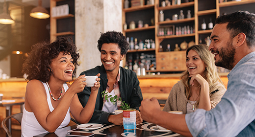 friends sitting at a table having coffee at a cafe