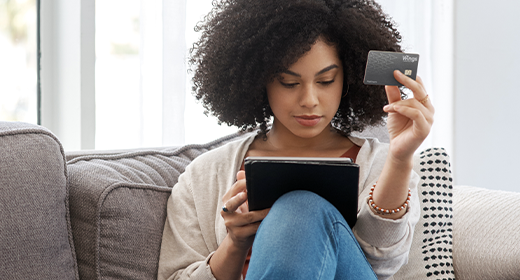 woman holding her tablet and wings platinum card_520x280