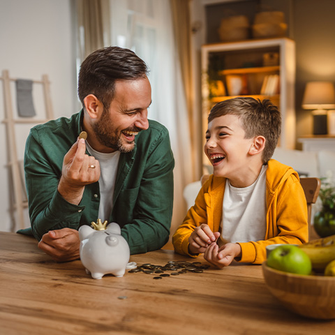 /getmedia/26946cc2 062e 4c9e aa20 be855c46733d/father and son saving change in a piggy bank_480x480