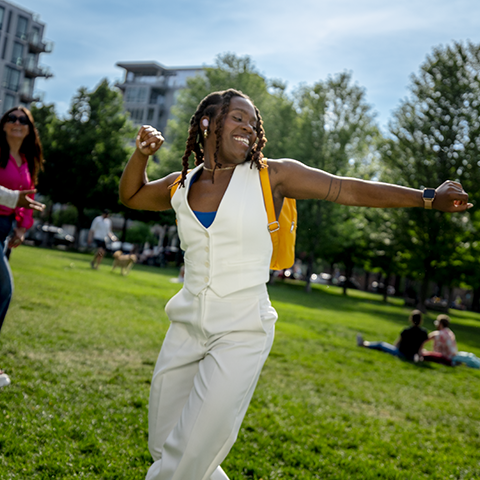 woman dancing in a public park_480x480