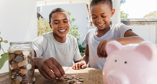 mother and daughter stacking coins near a piggy bank week 3