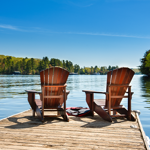 two chairs on a dock facing a lake_480x480