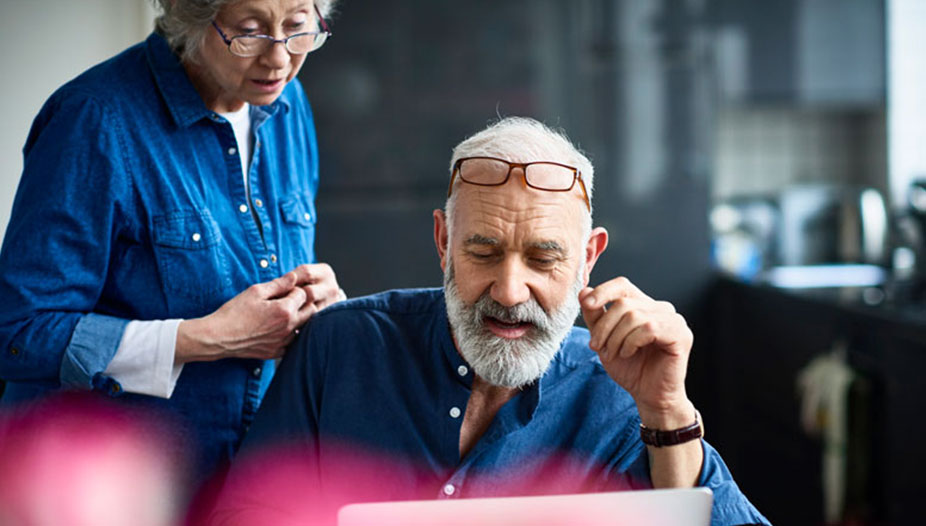 Older couple looking at a laptop computer