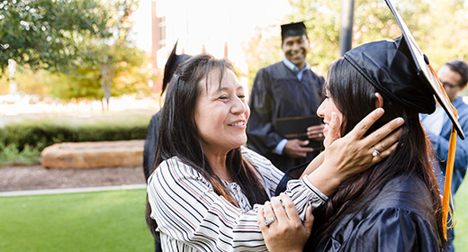 parent hugging child after graduation 520x280