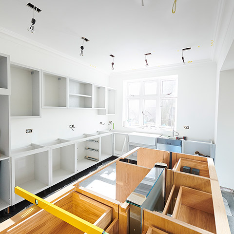 Kitchen in the middle of a renovation Counters and doors are off and drawers and cabnets are exposed