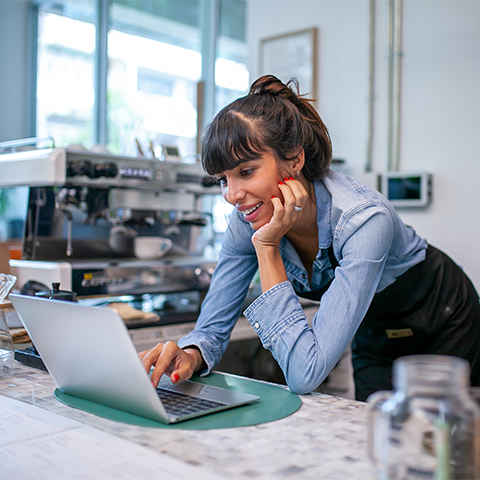 /getmedia/d60c7869 18bf 433d ae5a db8369755711/coffee shop owner working on her laptop_480x480