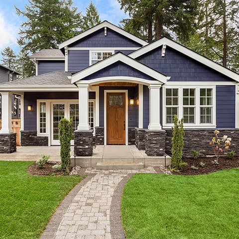 View from the front walkway of a two story home with blue siding and a red front door