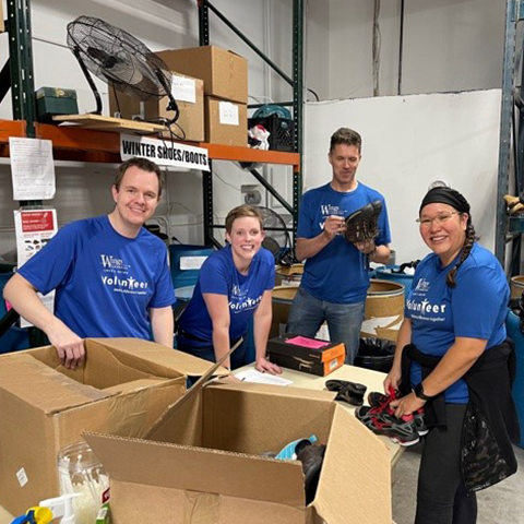 wings volunteers packing boxes with donations